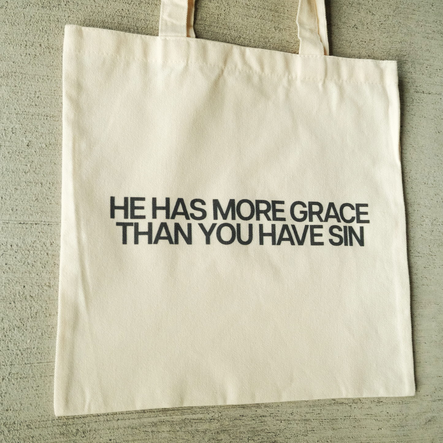 "HE HAS MORE GRACE" TOTE BAG