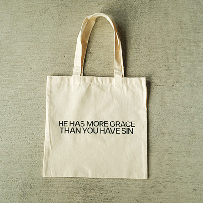 "HE HAS MORE GRACE" TOTE BAG